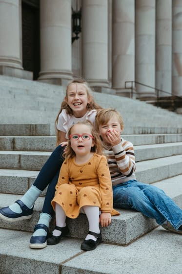 Kids sitting and laughing together in their spring outfits