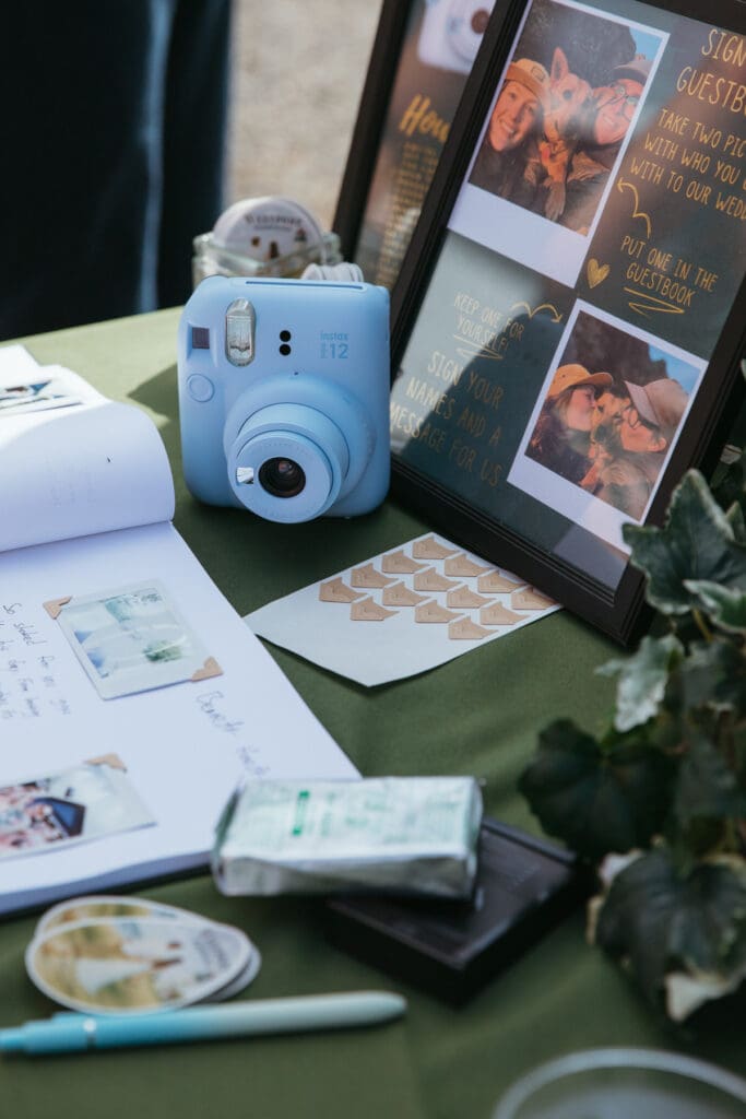 Guestbook table with a blue polaroid camera