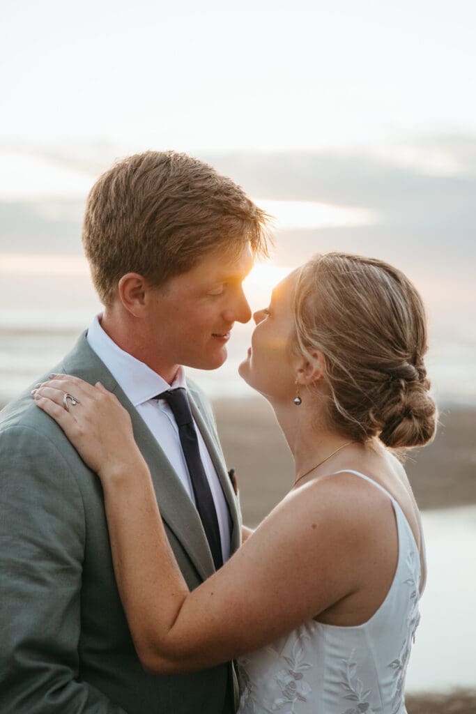 A kiss between a bride and groom after their backyard wedding