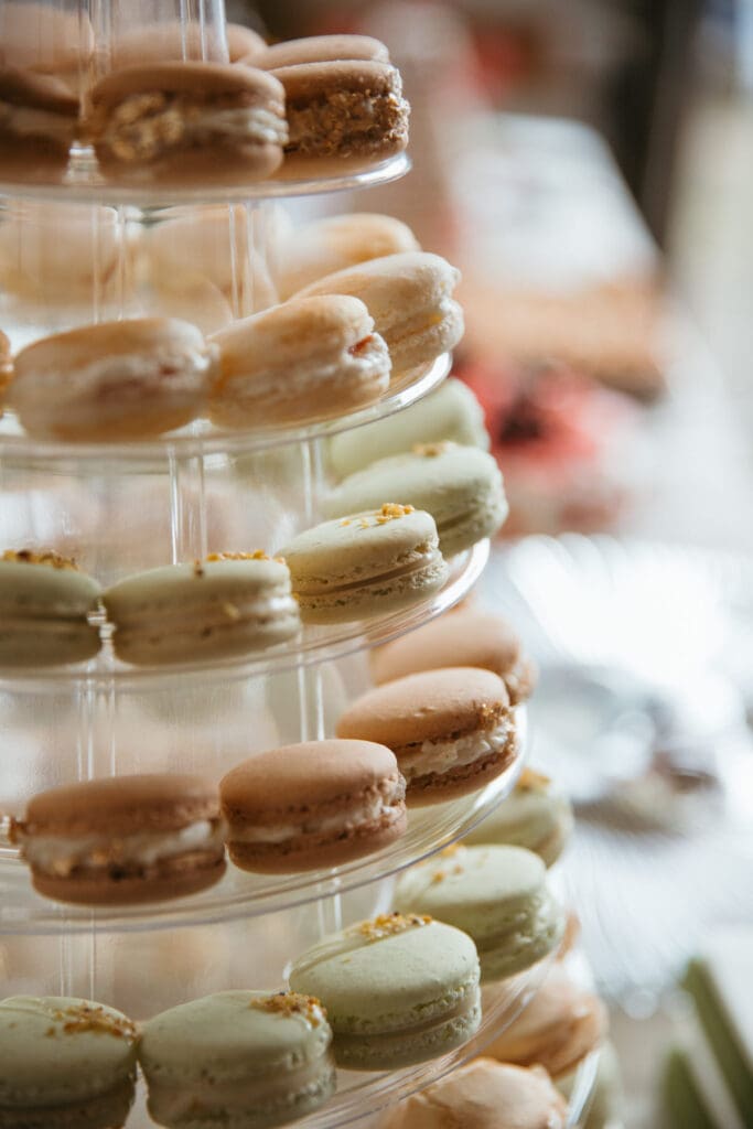A stack of macaroons colored pink and sage green