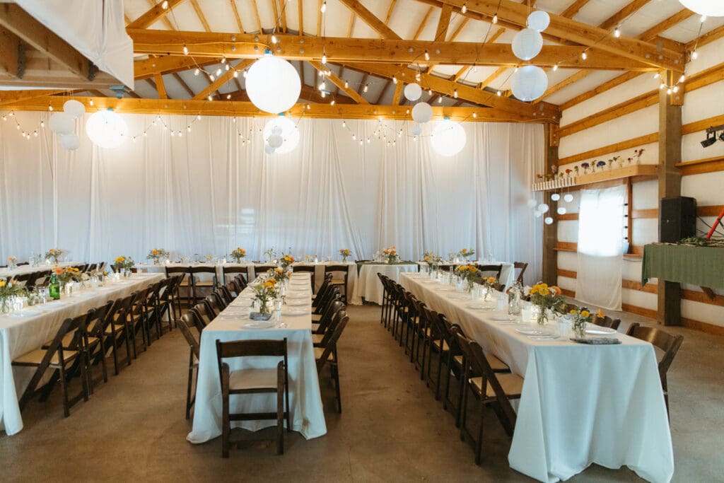 A reception area with tables and chair and decorative lighting