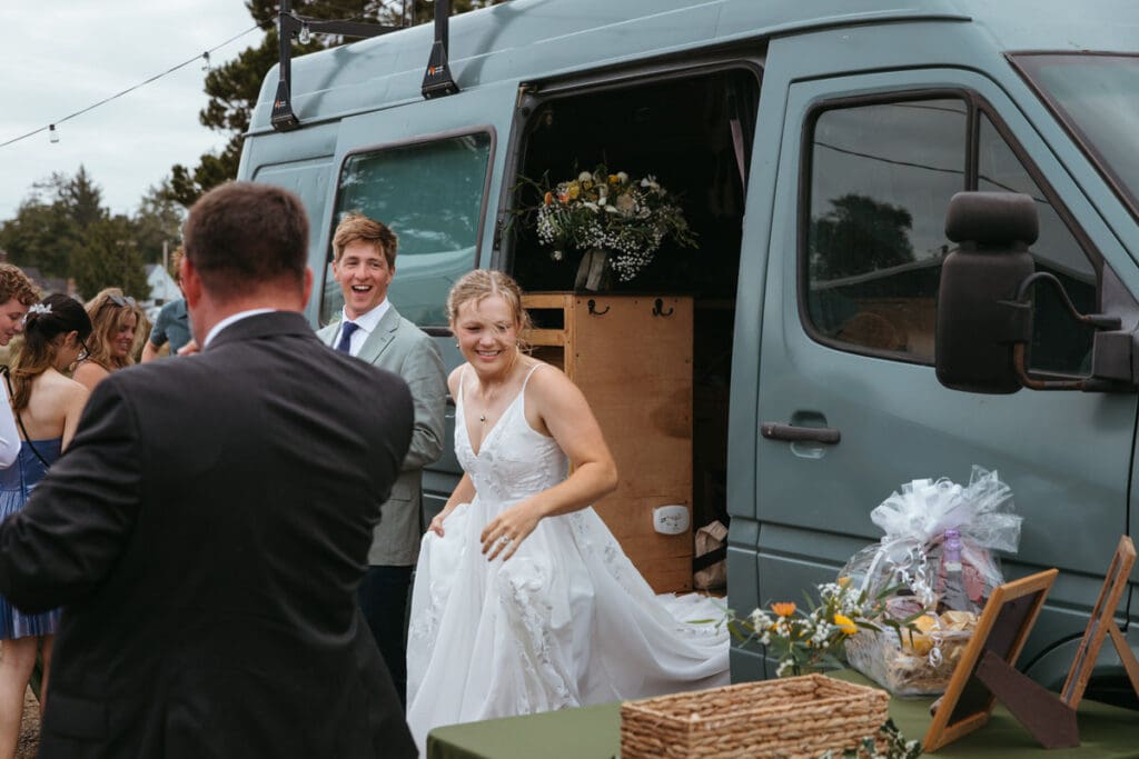 A backyard wedding with a bride and groom leaving their travel van